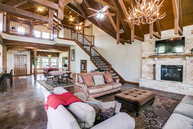 living room with beam ceiling, a stone fireplace, high vaulted ceiling, concrete floors, and ceiling fan with notable chandelier