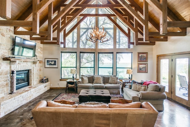 living room featuring a stone fireplace, beamed ceiling, high vaulted ceiling, and a notable chandelier