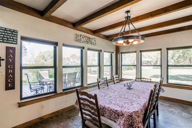 dining area with plenty of natural light and beamed ceiling