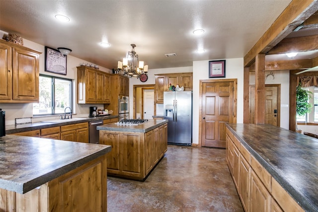 kitchen with a wealth of natural light, a center island, stainless steel appliances, and a notable chandelier