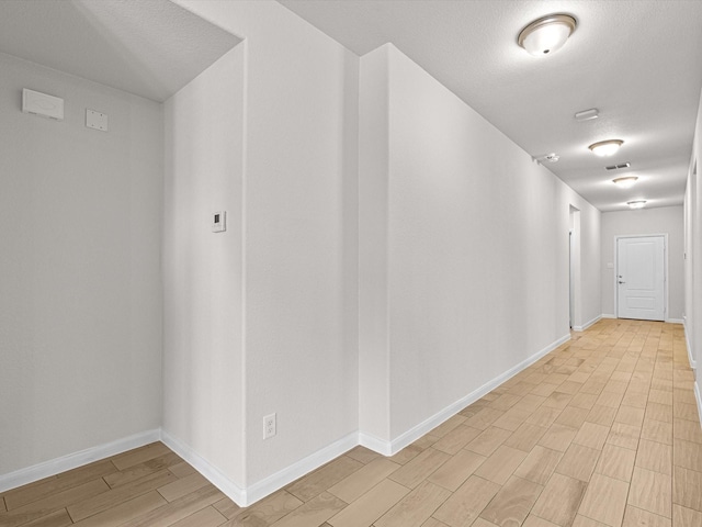 hall with light hardwood / wood-style floors