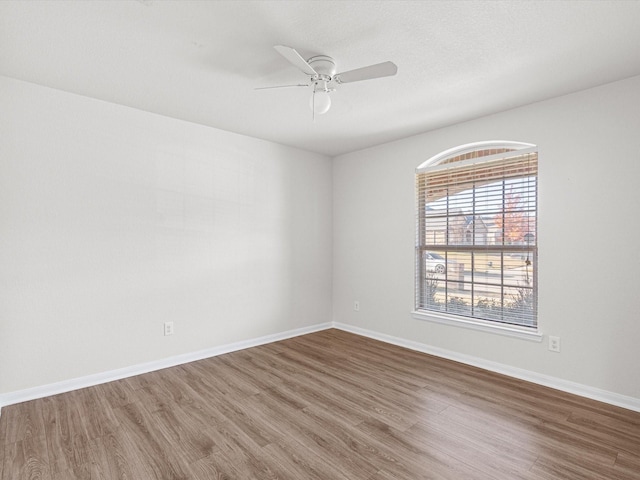 unfurnished room with ceiling fan and wood-type flooring