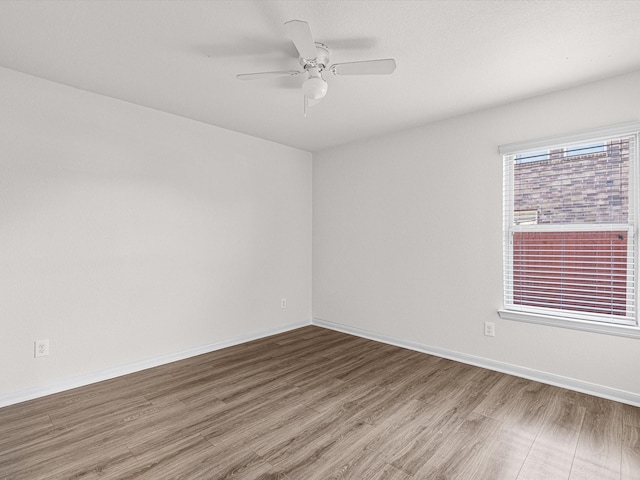 spare room with ceiling fan and hardwood / wood-style floors