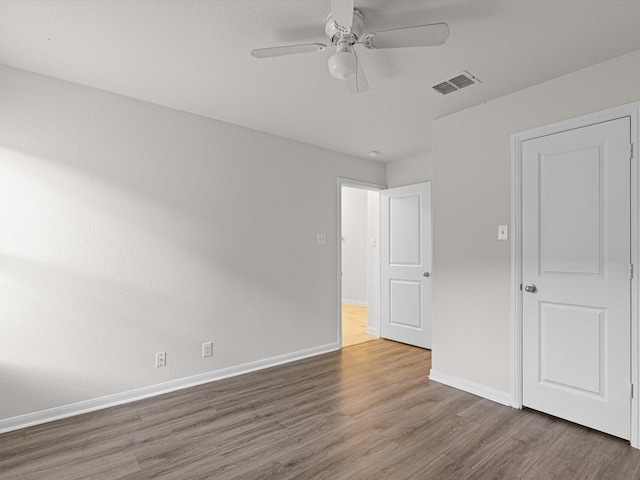 unfurnished bedroom featuring ceiling fan and hardwood / wood-style floors