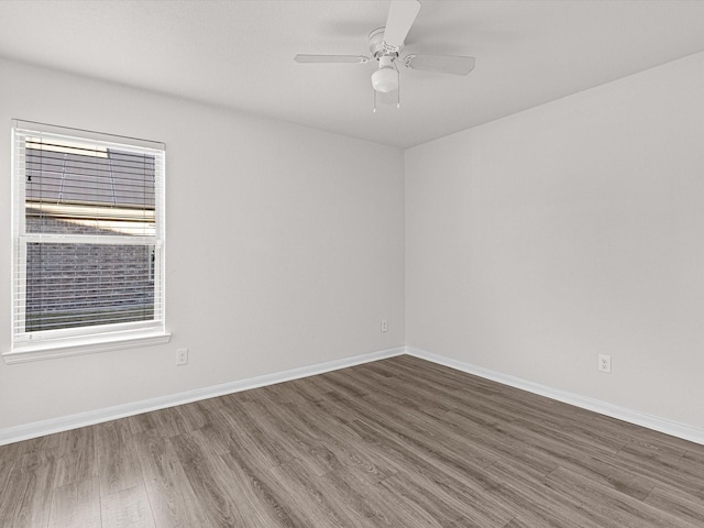 spare room featuring dark hardwood / wood-style floors and ceiling fan