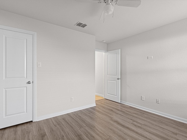 spare room featuring ceiling fan and light hardwood / wood-style flooring