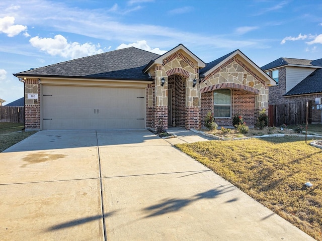 view of front of property featuring a front lawn and a garage