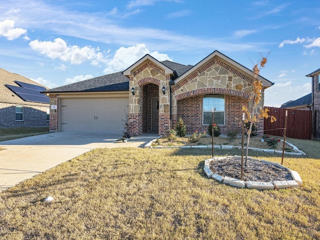 view of front of property with a front yard and a garage