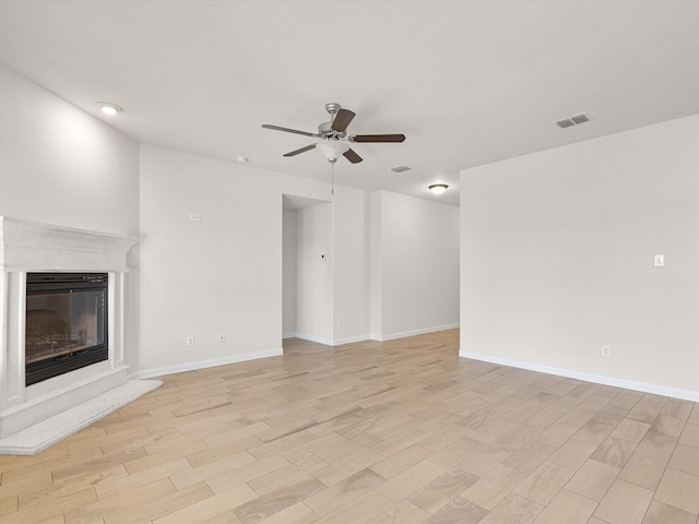 unfurnished living room with ceiling fan and light wood-type flooring