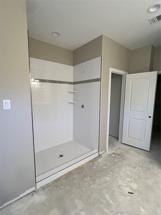 bathroom featuring a shower and concrete flooring