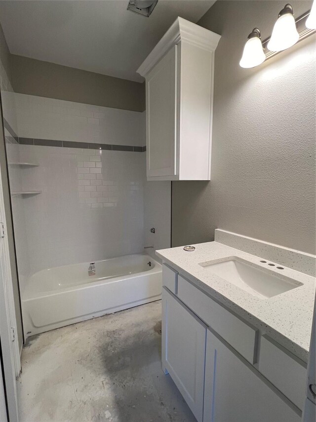 bathroom featuring vanity, tiled shower / bath, and concrete floors