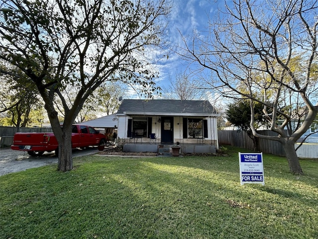 view of front of home with a porch and a front lawn