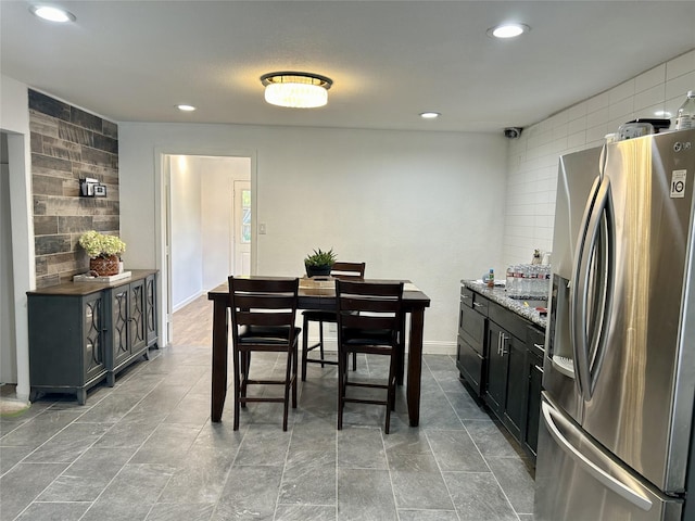 dining space featuring baseboards and recessed lighting