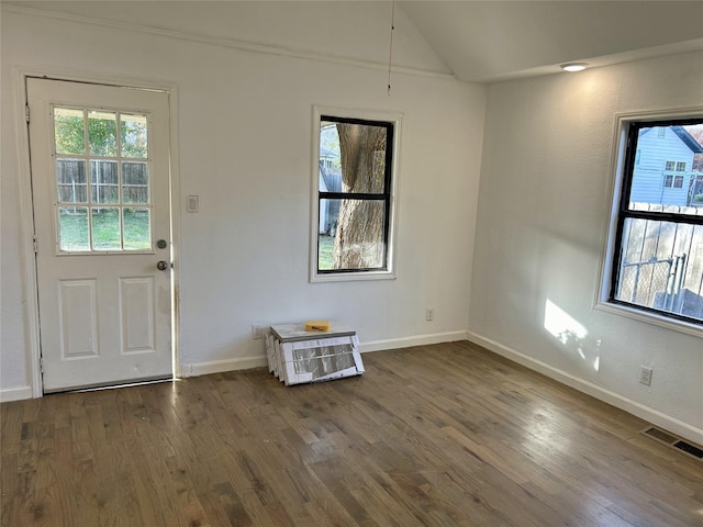 foyer featuring dark wood-style floors, lofted ceiling, visible vents, and baseboards