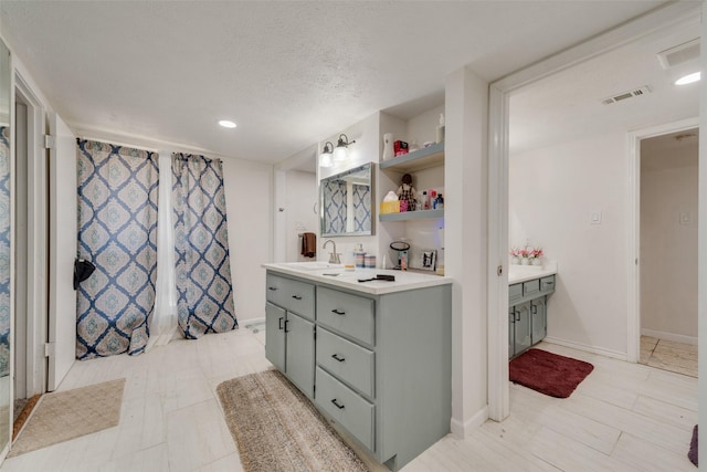 bathroom featuring vanity and a textured ceiling