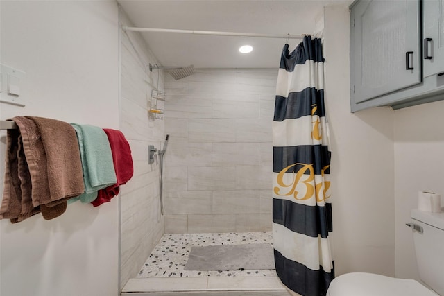 bathroom featuring toilet and walk in shower