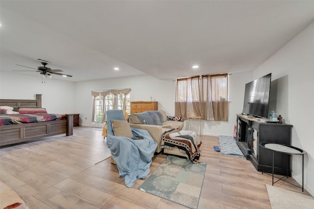 living room with light wood-type flooring and ceiling fan