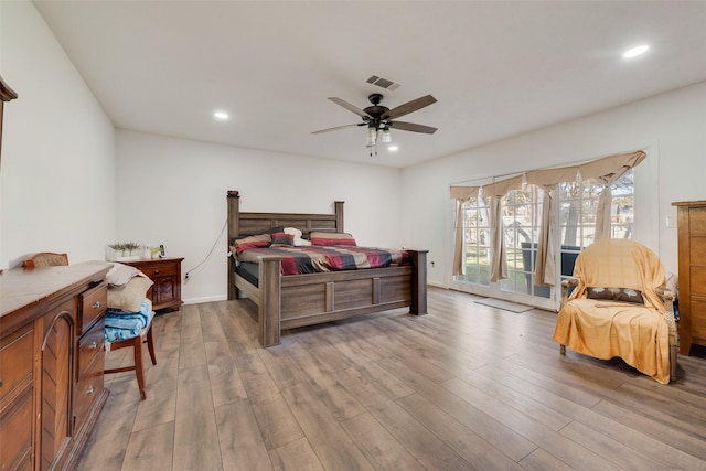 bedroom featuring hardwood / wood-style floors, ceiling fan, and access to outside