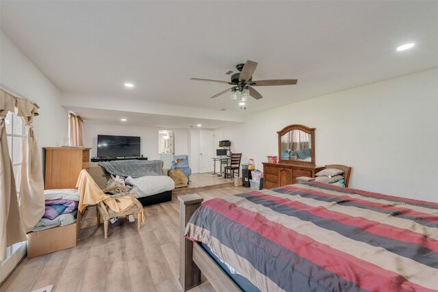 bedroom with ceiling fan and light hardwood / wood-style floors