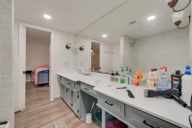 bathroom with hardwood / wood-style floors and vanity