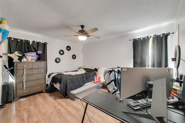 bedroom with light wood-type flooring and ceiling fan