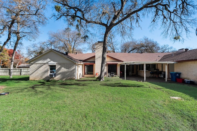 rear view of house with a yard