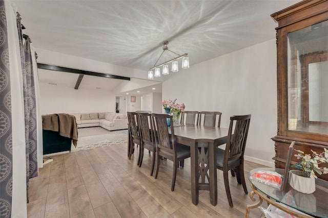 dining space featuring beamed ceiling, light hardwood / wood-style floors, and a notable chandelier