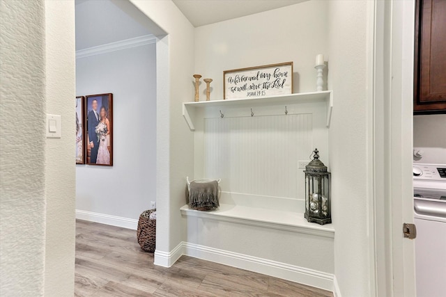 mudroom featuring ornamental molding, washer / clothes dryer, and light hardwood / wood-style flooring