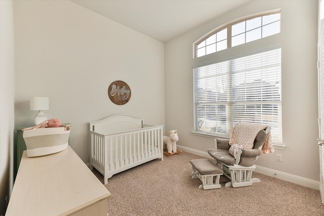 carpeted bedroom with a crib