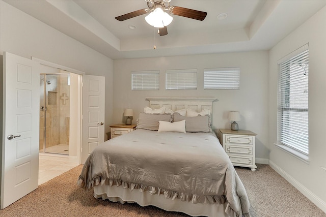 bedroom with ceiling fan, a raised ceiling, and light carpet