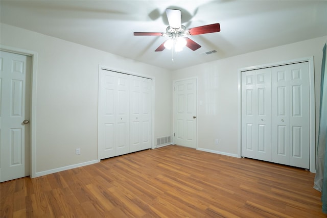 508 Squires Ln, Krugerville, TX 76227 - unfurnished bedroom with two closets, baseboards, visible vents, and light wood-type flooring