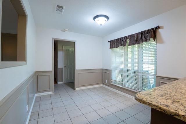 508 Squires Ln, Krugerville, TX 76227 - dining area with wainscoting, light tile patterned flooring, and visible vents