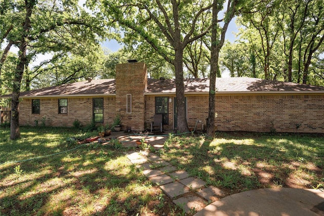 508 Squires Ln, Krugerville, TX 76227 - rear view of property with a patio, roof with shingles, a chimney, brick siding, and a lawn
