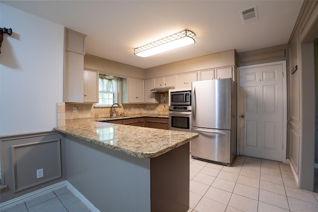 508 Squires Ln, Krugerville, TX 76227 - kitchen with appliances with stainless steel finishes, a sink, a peninsula, light tile patterned floors, and visible vents