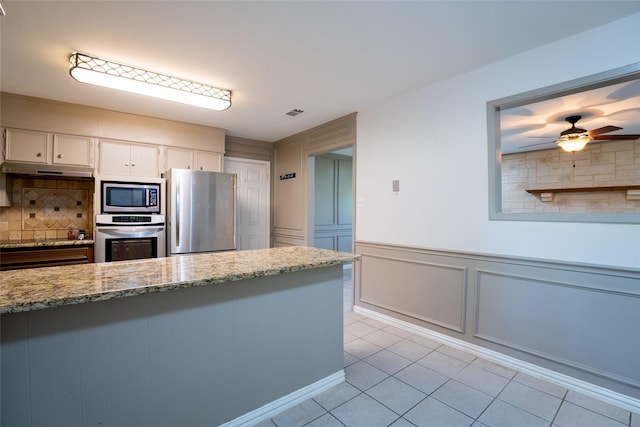 508 Squires Ln, Krugerville, TX 76227 - kitchen featuring white cabinetry, light tile patterned floors, light stone countertops, and stainless steel appliances