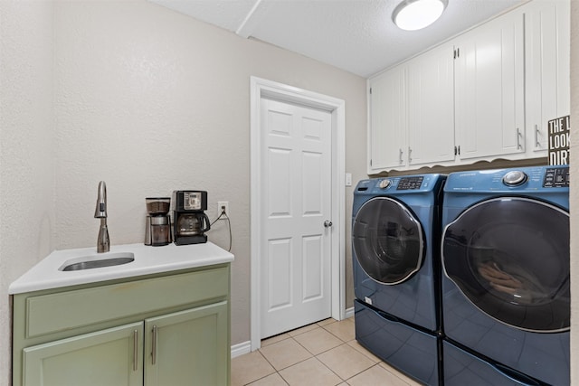 clothes washing area featuring cabinets, light tile patterned floors, separate washer and dryer, and sink