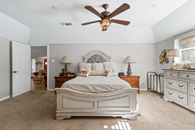 carpeted bedroom with ceiling fan and lofted ceiling