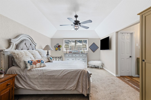 bedroom featuring a textured ceiling, ceiling fan, hardwood / wood-style floors, and vaulted ceiling