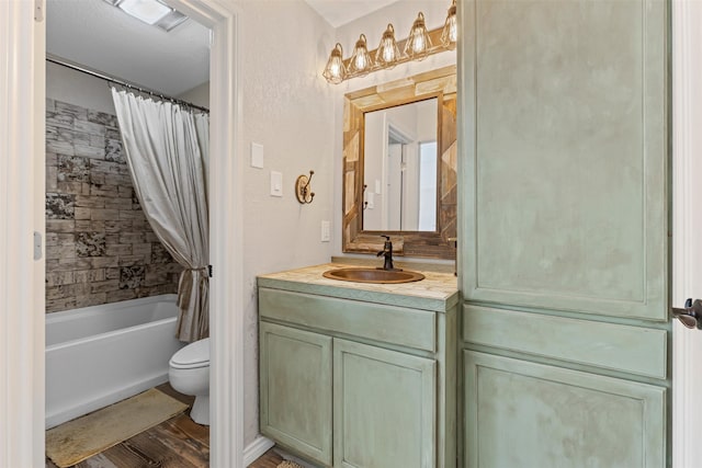 full bathroom with hardwood / wood-style flooring, vanity, toilet, and shower / tub combo