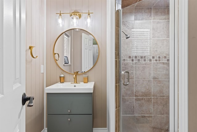 bathroom featuring vanity, an enclosed shower, and wooden walls