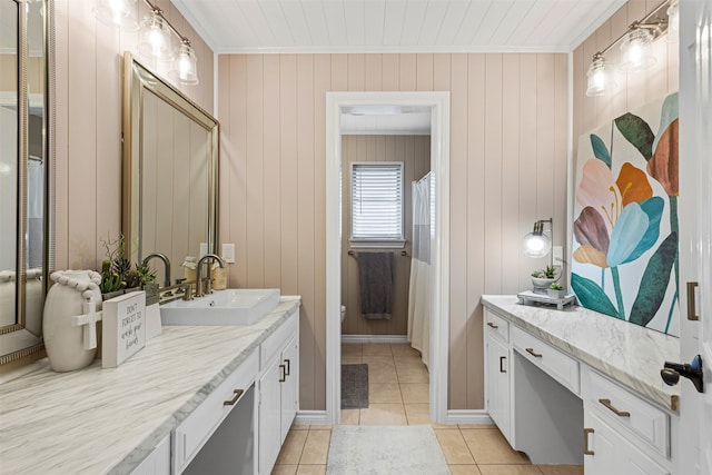 bathroom with wooden walls, tile patterned flooring, vanity, and toilet