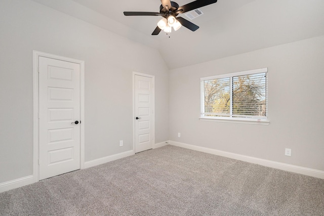 unfurnished bedroom with ceiling fan, carpet, and lofted ceiling