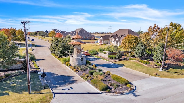 view of home's community featuring a lawn