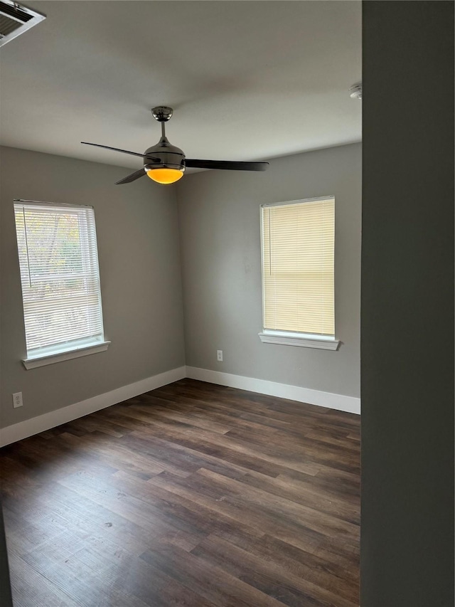 unfurnished room featuring ceiling fan and dark hardwood / wood-style flooring