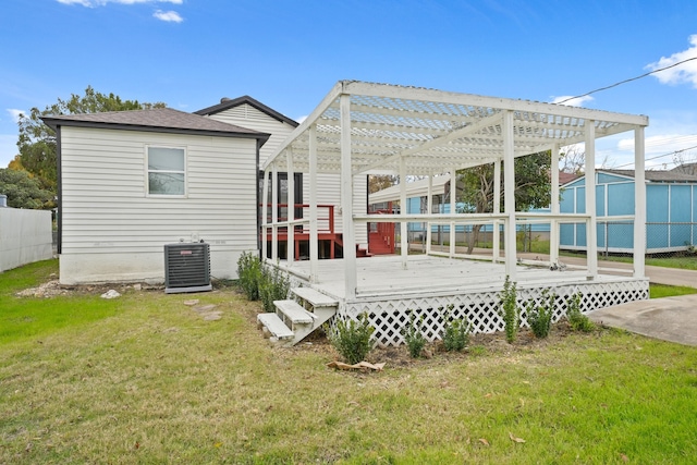 back of house with a pergola, a lawn, central AC unit, and a deck