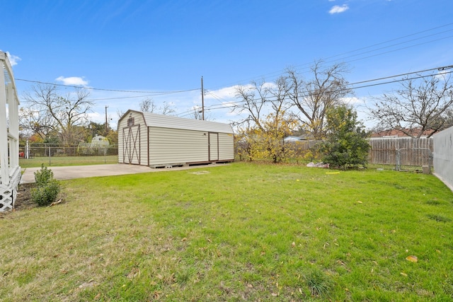 view of yard with a storage unit and a patio area