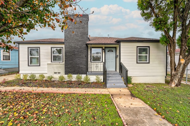 bungalow-style house with a front yard