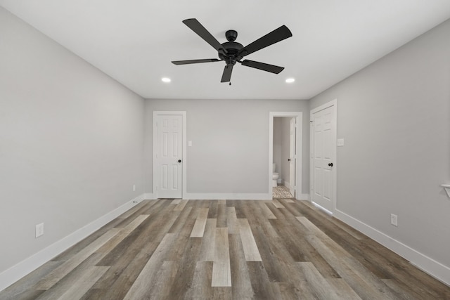 empty room with ceiling fan and light wood-type flooring