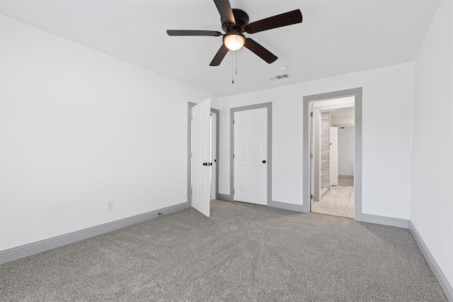 unfurnished bedroom with ceiling fan and light carpet