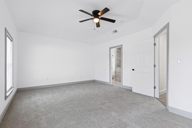 carpeted spare room with ceiling fan